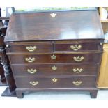 A George III mahogany bureau with brass fittings, the fall front enclosing a fitted interior,