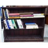 An early 20thC stained, planked pine open front bookcase with two height adjustable shelves,