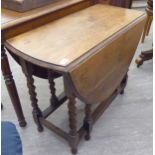 A 1920s light oak gateleg table, the oval top raised on a barleytwist and block underframe,