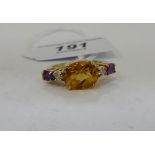 A 9ct gold ring, set with a central citrine,