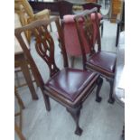 A set of six 1920s Chippendale inspired mahogany framed dining chairs with yoke crests and ribbon