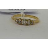 A yellow metal five stone diamond ring 11