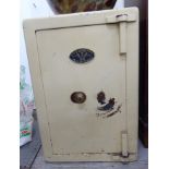 An early 20thC cream painted steel office safe, bears the label J Cartwright & Son,