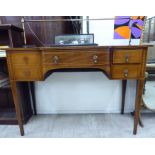 An Edwardian ebony and string inlaid breakfront sideboard with a brass galleried upstand,