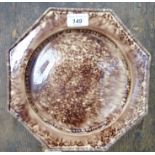 A late Victorian majolica sponged and drip glazed brown earthenware dish of octagonal from with a