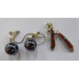 A pair of silver haematite and pearl pendant earrings; and a dissimilar pair set with silver,
