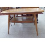 An Ercol light elm occasional table, the top incorporating pierced, cut-out handles,