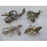 Four dissimilar silver coloured/white metal brooches 11