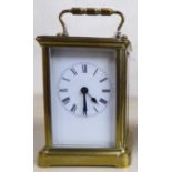 An early/mid 20thC lacquered brass cased carriage timepiece with bevelled glass panels and a