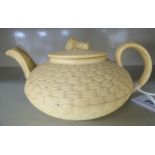 An early 19thC Wedgwood cream glazed and basketweave moulded small, round teapot,