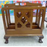 A 1920s/30s mahogany magazine rack with three latticed dividers and a cut-out handle,
