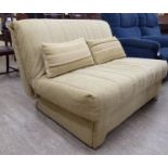 A modern two person futon, upholstered in textured oatmeal coloured fabric,