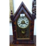 An early 20thC American walnut polished arch cased mantel clock with finials and a fully glazed