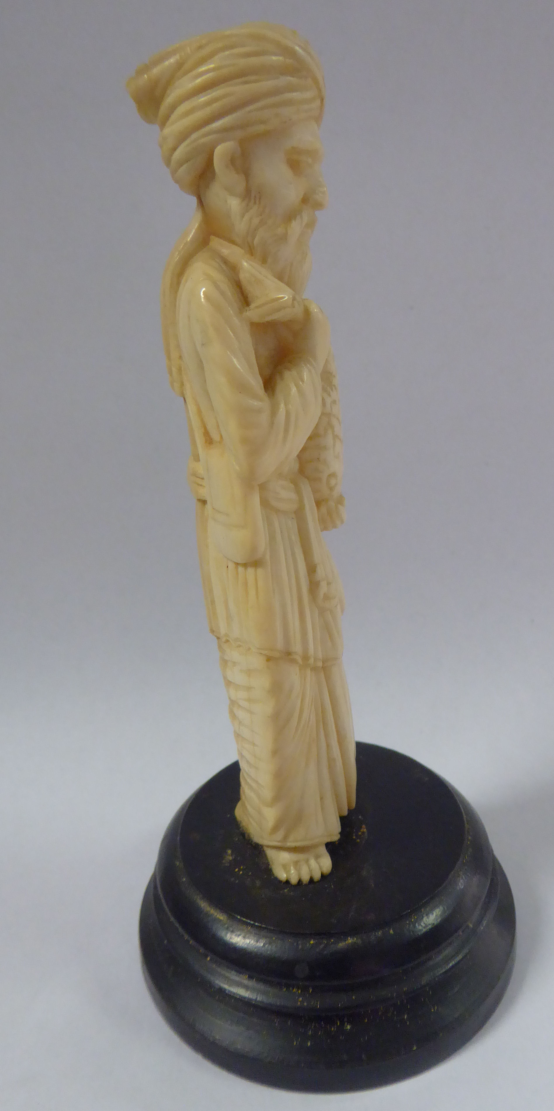 An early 20thC Asian carved ivory standing figure, a bearded man, wearing a turban and robes, - Image 4 of 6