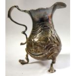 A George II silver cream jug of waisted, bulbous form, having a flared,