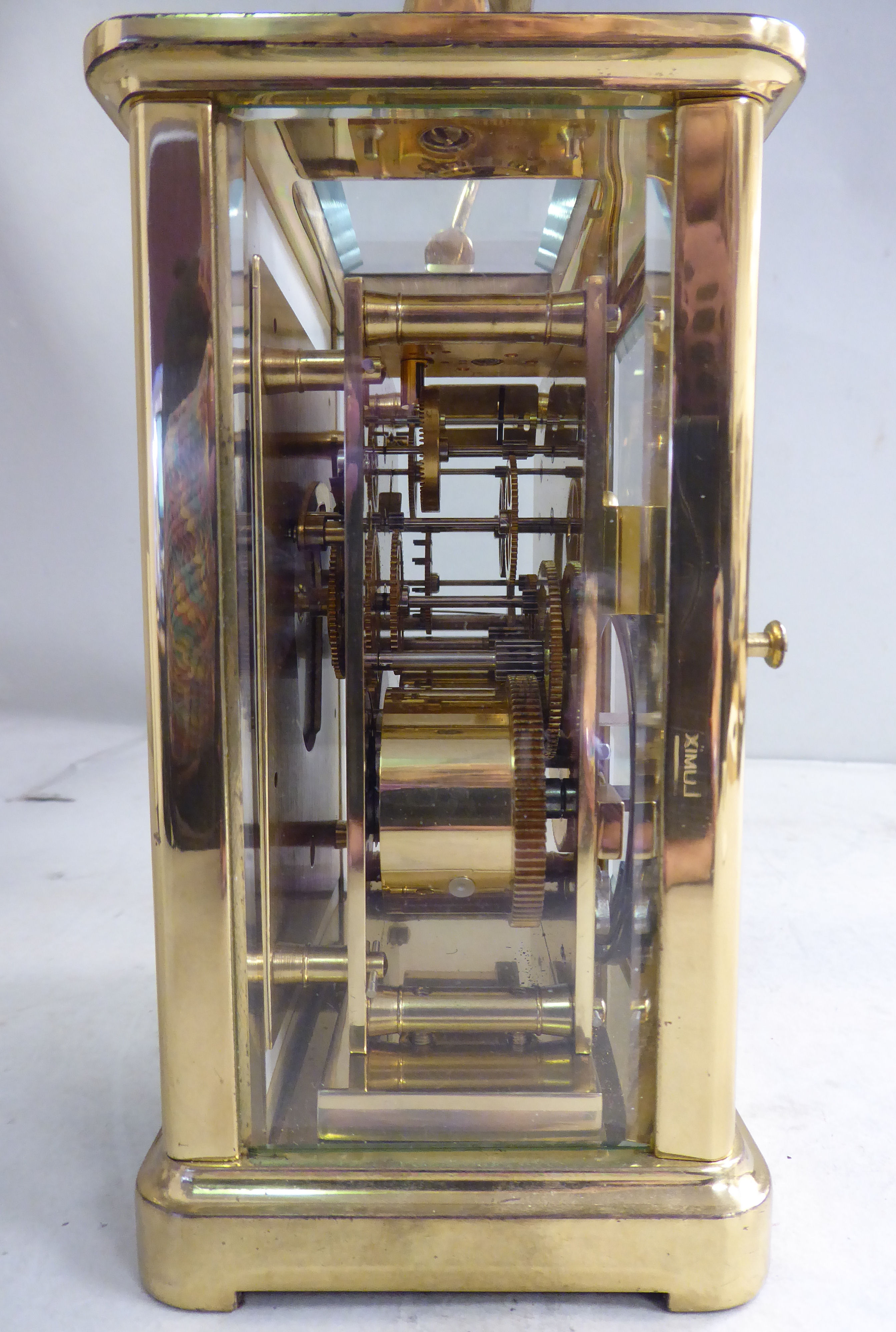 A mid 20thC lacquered brass cased carriage clock with bevelled glass panels and a folding top - Image 2 of 5