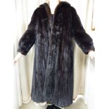 WITHDRAWN A lady's full-length black mink fur coat with a rolled collar bears the label