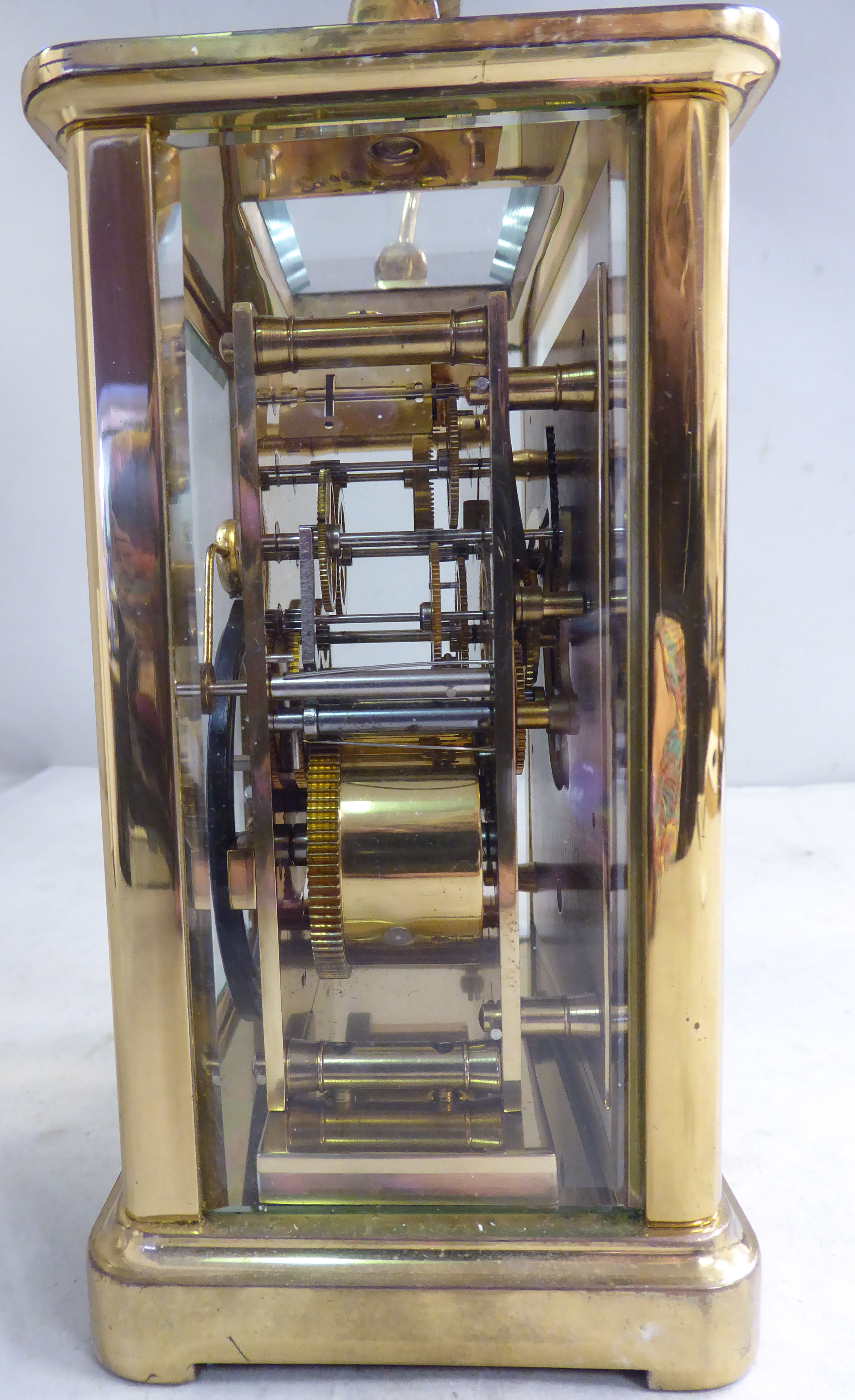 A mid 20thC lacquered brass cased carriage clock with bevelled glass panels and a folding top - Image 4 of 5