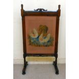 A William IV rosewood framed firescreen, set with a tapestry panel,