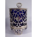 A 19thC silver coloured metal framed mustard pot of drum design with a blue glass liner and