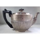 A late Victorian silver teapot of oval, demi-reeded form with a swept spout,