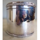 A silver drum design biscuit box with cast gadrooned border ornament and an outset hinge on the