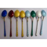 A set of eight Danish silver gilt coffee spoons, individually decorated in colours with banded,