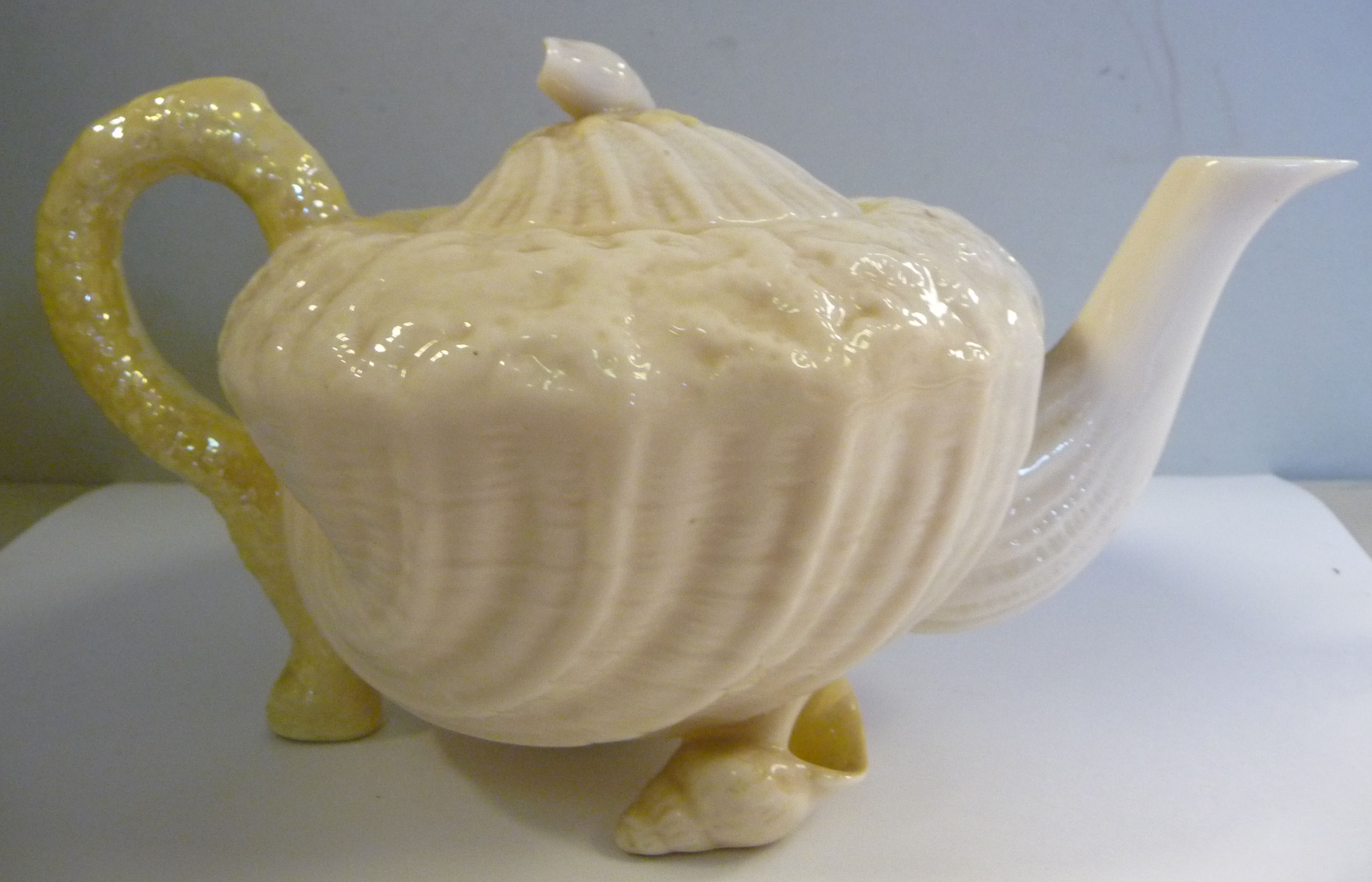 A Belleek cream coloured and tinted yellow lustre glazed,