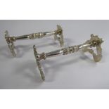 A pair of George III silver knife rests, cast with rosettes,