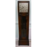 A 1930s oak longcase clock of box design,