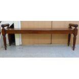 A William IV mahogany window seat, the solid top with pillow ends, raised on block, turned, tapered,
