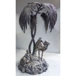 A late Victorian silver plated table centrepiece, featuring a seated Arab and a standing camel,