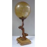 An Art Deco table lamp, fashioned as a bronze coloured spelter kneeling figure,