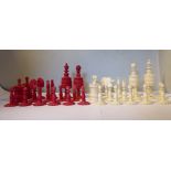 A late 19th/early 20thC turned and carved naturally coloured and beetlenut stained bone chess set