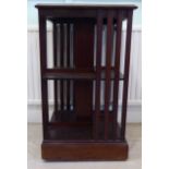 An Edwardian mahogany two tier revolving bookcase, the top with marquetry and crossbanded ornament,