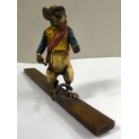 An early 20thC painted cold cast bronze model, a mouse wearing breeches and a sash,