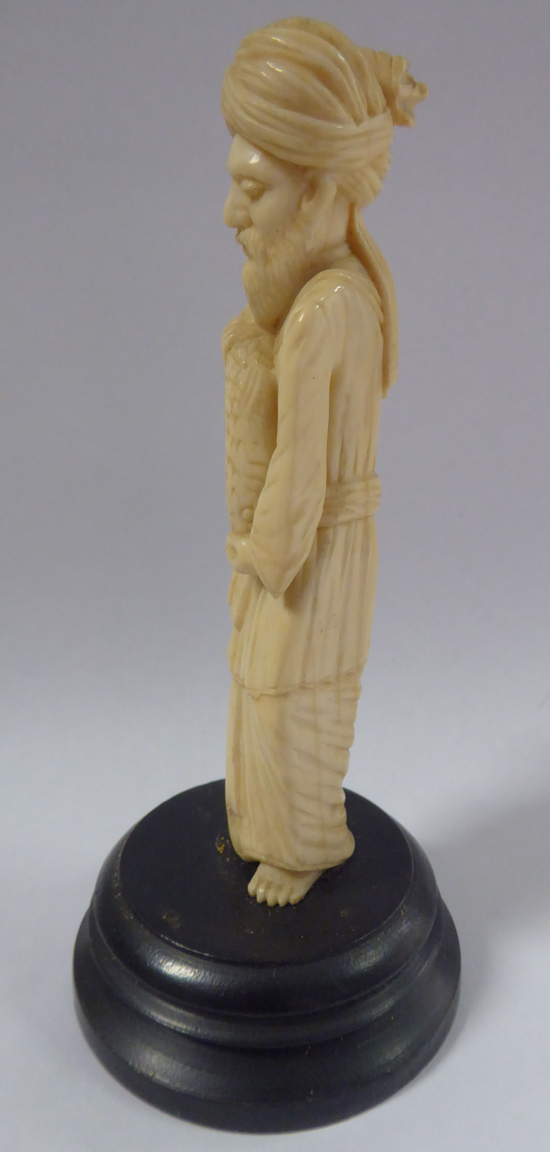 An early 20thC Asian carved ivory standing figure, a bearded man, wearing a turban and robes, - Image 2 of 6