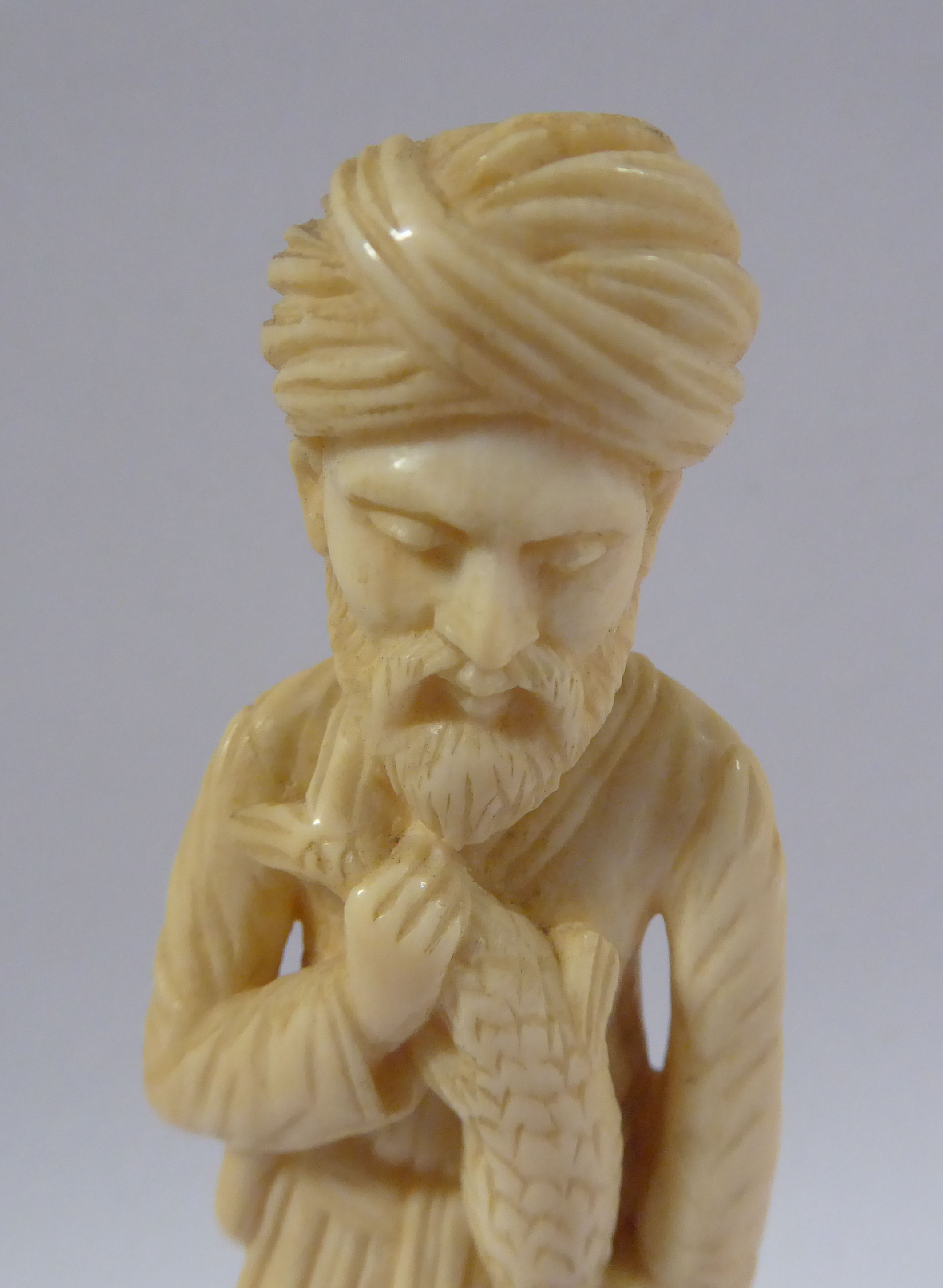 An early 20thC Asian carved ivory standing figure, a bearded man, wearing a turban and robes, - Image 5 of 6