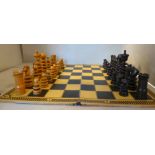 An early 20thC St George pattern turned and carved boxwood and rosewood chess set Kings 4''h with a