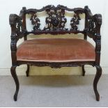 An Edwardian rococo design mahogany window seat with an ornately carved and pierced splat-back and
