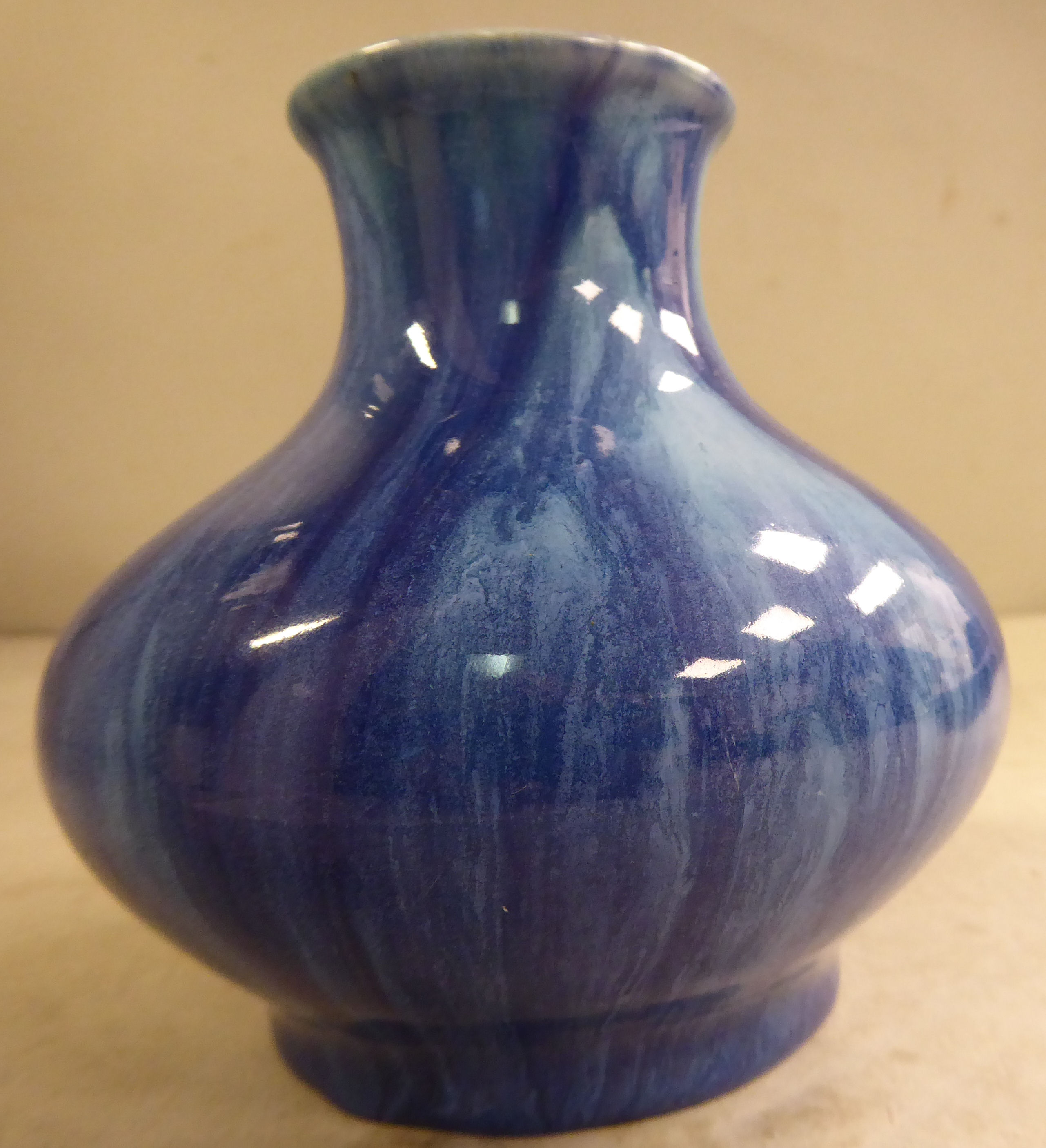 A Royal Lancastrian streaky blue drip glazed pottery vase of squat,