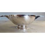A silver quaiche design bowl with opposing, hollow tab handles,