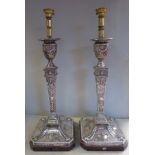 A pair of Edwardian loaded silver neo-classically inspired candlestick design table lamps of square