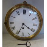 A late 19thC brass drum cased wall timepiece; the movement faced by a white enamel Roman dial,