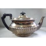 An Edwardian silver teapot of oval, ogee, demi-reeded form with a swept spout,