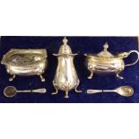 A three piece silver condiments set of cauldron design with gadrooned borders comprising an oval