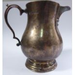 A Georgian style silver bulbous, sparrow's beak cream jug with a cast, double C-scrolled handle,