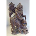 An early/mid 20thC Asian carved hardwood table lamp, an allegorical figure,