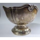 A silver rose bowl of segmented form with a shell cast, serpentine outlined wire rim,
