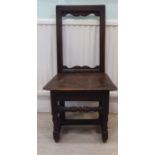 A late 17thC child's oak framed chair with a high, open, rectangular back,